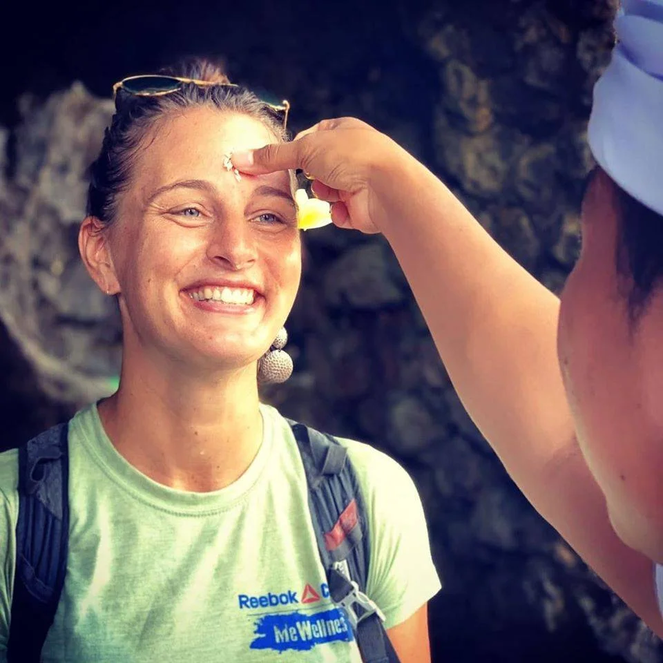 a woman is getting her eyebrows pierced by a man in a cave.