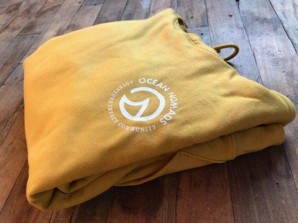 Ocean Nomads Hoodie - Unisex yellow hoodie with a white logo.