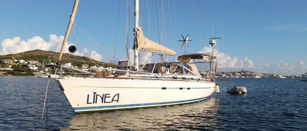 a sailboat docked in a body of water.