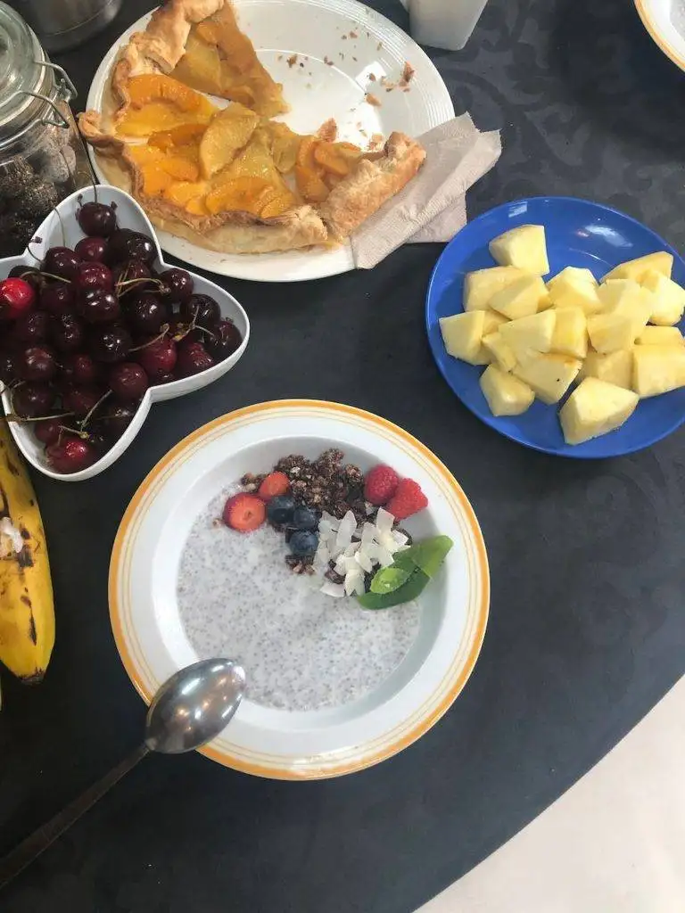 a table full of fruit and a bowl of chia pudding.