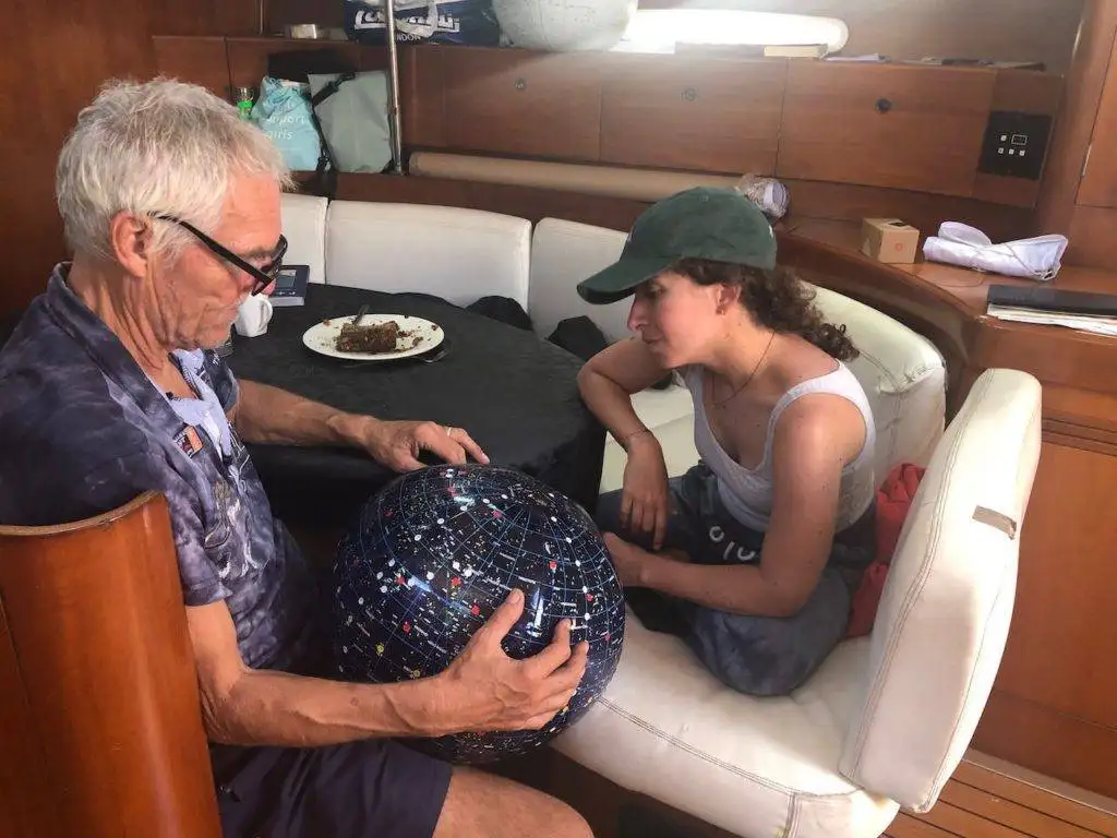 an older man and a young girl sitting on a boat.