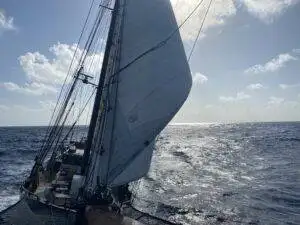 a sailboat sailing in the open ocean.