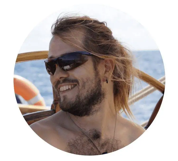 a man wearing sunglasses and a beard on a boat.