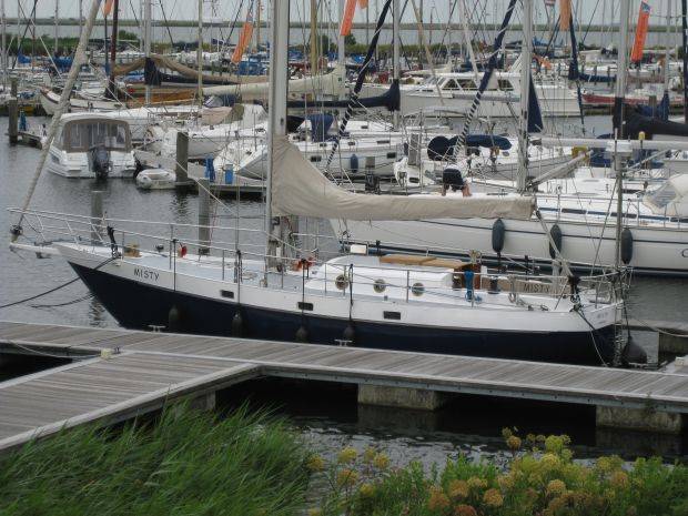 Female liveaboard sailor on her classic steel sailing yacht