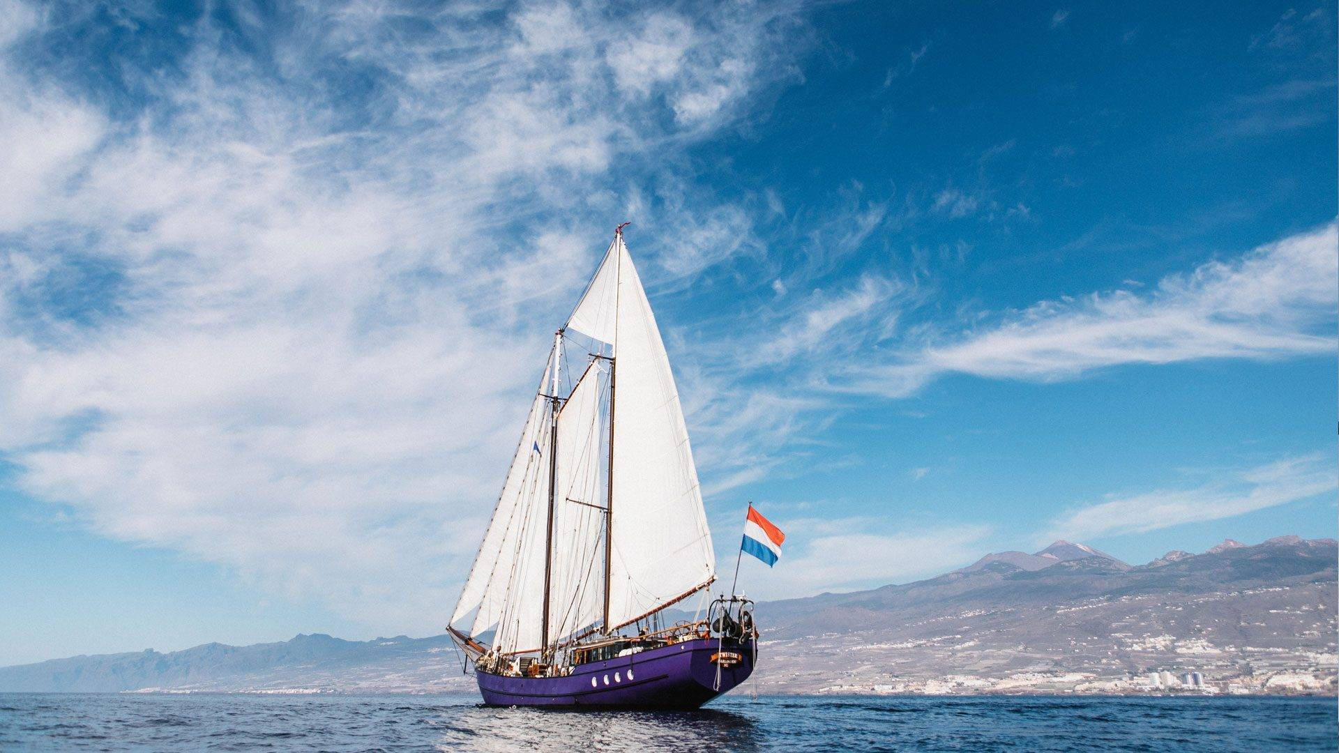 SV Twister, a 1902 wooden schooner, sailing offshore on an Ocean Nomads Atlantic expedition
